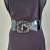 Black faux leather belt with buckle. Elastic at back. Black