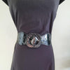 Black faux leather belt with buckle. Elastic at back. Black