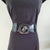 Black faux leather belt with buckle. Elastic at back. Black